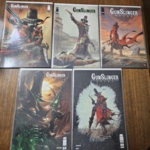 May include: A collection of five Gunslinger Spawn comic books, each featuring a character in a wide-brimmed hat and red coat. The covers display various action scenes with guns, chains, and desert landscapes, with the title Gunslinger Spawn printed.