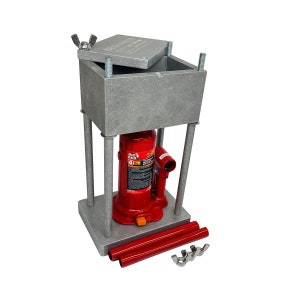 May include: A gray metal hydraulic press with a red hydraulic jack. The press has a removable top and comes with two red extension rods and four nuts.
