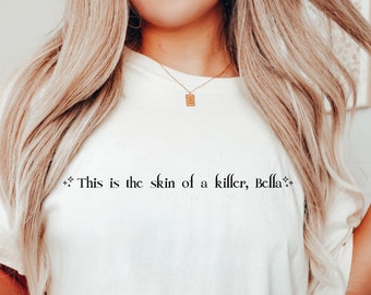 May include: White oversized t-shirt with the text "This is the skin of a killer, Bella." printed in black.