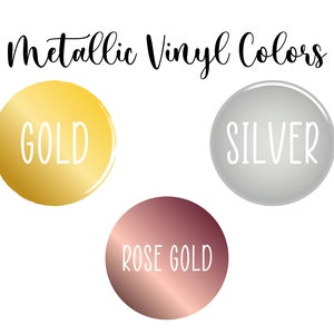 May include: Image showcasing metallic vinyl colors: gold, silver, and rose gold. Each color is displayed within a circular shape, with the color name written in white script. The text "Metallic Vinyl Colors" is at the top.