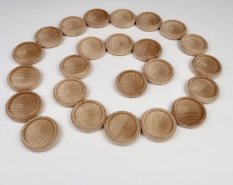 May include: A spiral arrangement of 20 natural wood round discs, each with a slightly raised edge, on a white background.