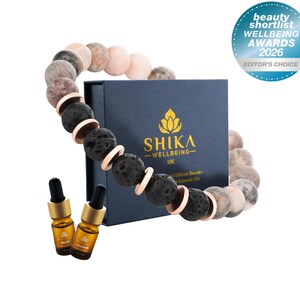 May include: A white ceramic mug with a black handle and the text "But first, coffee" in a handwritten style. The mug is on a white surface. The mug is 10 cm tall.