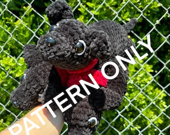May include: Three black crocheted dog plushies with red yarn scarves. The plushies are arranged in a stack with the largest plush on top. The plushies have black eyes and are made with a fuzzy yarn.
