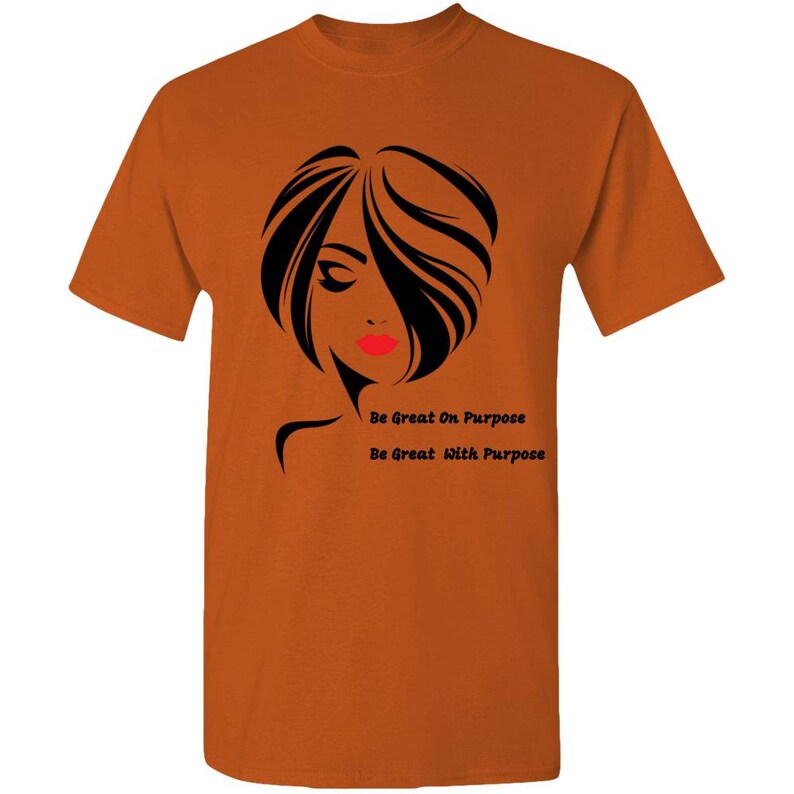 May include: Orange t-shirt with a black silhouette of a woman's face and the text "Be Great On Purpose" and "Be Great With Purpose".