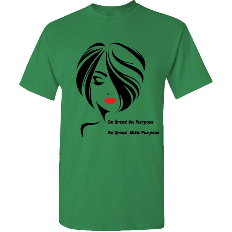 May include: Green t-shirt with a black and white silhouette of a woman with red lips. The text "Be Great On Purpose" and "Be Great With Purpose" is printed on the shirt.