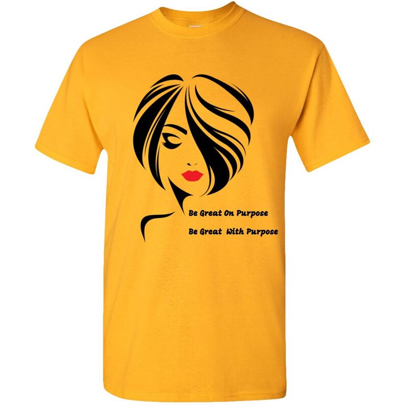 May include: A yellow t-shirt with a black silhouette of a woman with red lips and the text "Be Great On Purpose" and "Be Great With Purpose".