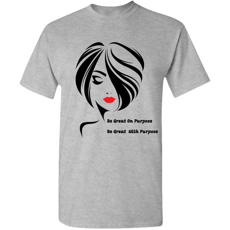 May include: Gray t-shirt with a black and white illustration of a woman with red lips. The text "Be Great On Purpose" and "Be Great With Purpose" is printed on the shirt.