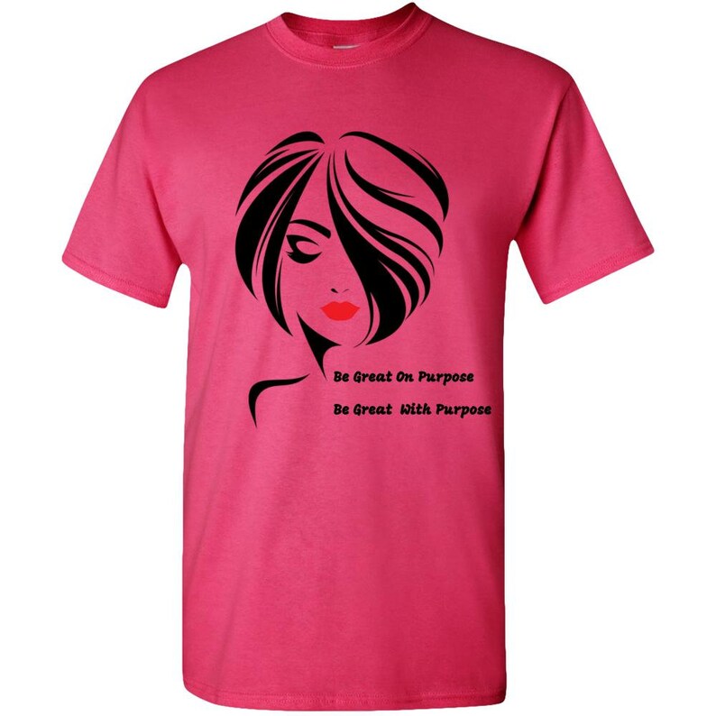 May include: Pink t-shirt with a black and white silhouette of a woman with red lips. The text "Be Great On Purpose" and "Be Great With Purpose" is printed on the shirt.