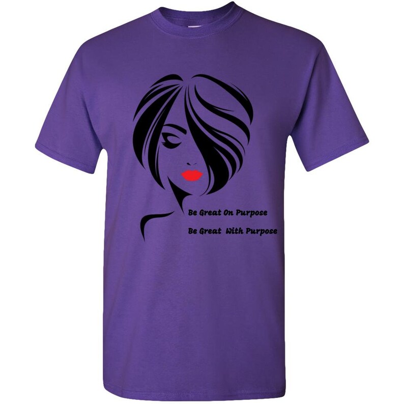 May include: Purple t-shirt with a black silhouette of a woman with red lips and the text "Be Great On Purpose" and "Be Great With Purpose".