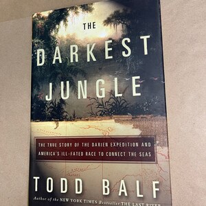 May include: Book cover with a dark green jungle scene and a map. The title is "The Darkest Jungle" and the author is "Todd Balf". The subtitle is "The true story of the Darien Expedition and America's ill-fated race to connect the seas".