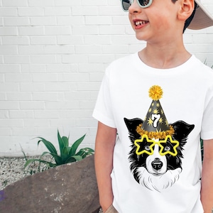 May include: A white t-shirt with a black and white border collie wearing a party hat with the number 7 on it and star-shaped sunglasses. The dog is wearing a party hat with the number 7 on it.