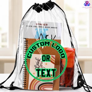 May include: A clear plastic drawstring backpack with black cord straps. Inside the bag is a book titled Winner Costa Children's Book Award, a spiral-bound notebook, and an orange patterned item. A green circular graphic reads Custom Logo Or Text.