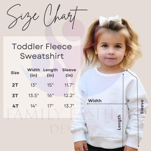 a little girl wearing a white sweater with a bow in her hair