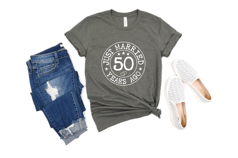 May include: A gray t-shirt with a white circle graphic that says "Just Married 50 Years Ago".