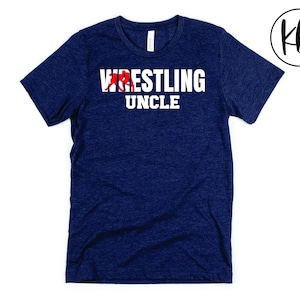 May include: A navy blue t-shirt with the text "Wrestling Uncle" in white letters. A red wrestler graphic is above the text.