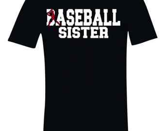 May include: Black t-shirt with white text that reads "Baseball Sister". A red baseball player graphic is to the left of the text.