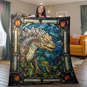 May include: A stained glass style quilt featuring a dragon with a yellow and brown body, red eyes, and a blue and green background.