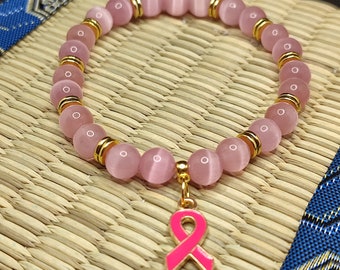 Bracelet octobre rose , bracelet perles oeil de chat, perles de qualité AAA