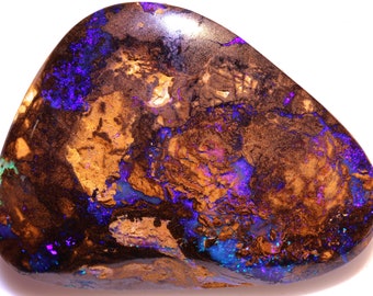 May include: A brown, purple, and blue opal gemstone with a smooth, rounded shape.
