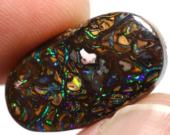 May include: A polished, oval-shaped opal gemstone. The stone features a dark brown base color with intricate patterns of gold, green, blue, and purple iridescence. A small, light-colored inclusion is visible near the top.
