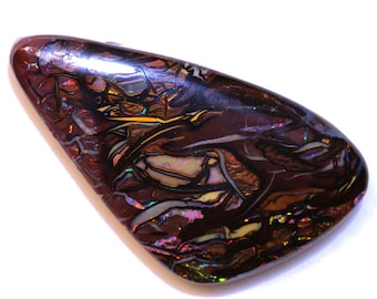 May include: A dark brown, iridescent opal with a unique pattern of swirling colors, including shades of purple, blue, green, and yellow.