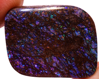 May include: A dark brown opal with a purple and green iridescent sheen. The opal has a rough, textured surface.