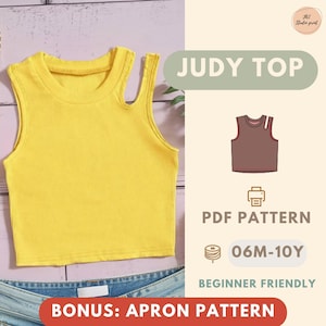May include: A bright yellow ribbed knit crop top with a unique shoulder cutout. The image also includes a PDF pattern for the "Judy Top", with sizes from 06 months to 10 years, and a bonus apron pattern. The design is beginner friendly.