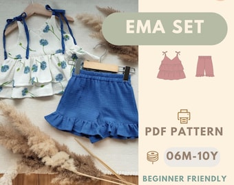 May include: A two-piece clothing set featuring a white sleeveless top with a blue floral print and tie-shoulder straps, paired with solid blue ruffled shorts. The image includes text: EMA SET, PDF PATTERN, 06M-10Y, BEGINNER FRIENDLY, and BONUS: APRON PATTERN.