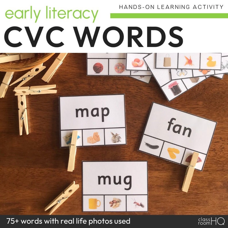 May include: A set of CVC word cards with real-life photos. The cards feature the words "map", "mug", and "fan". Each card has three squares with a picture in each square. The pictures are a map, a mug, and a fan. There are also wooden clothespins on the table.