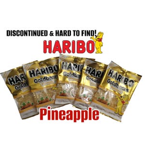 May include: Five gold-colored Haribo Goldbears Pineapple gummy candy bags. The bags have the Haribo logo and the words "Goldbears Pineapple" printed on them. The text "DISCONTINUED & HARD TO FIND!" and "Pineapple" are also visible.