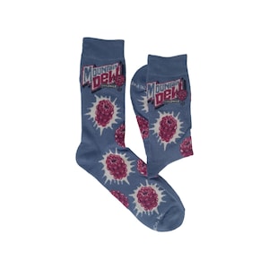 May include: A pair of blue crew socks featuring a repeating pattern of red raspberries with white starburst accents. The upper portion of each sock displays the Mountain Dew Voltage logo in white, red, and blue text against the blue fabric background.