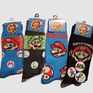 May include: Four pairs of crew socks featuring Super Mario characters. The socks have various designs, including Mario, Luigi, and mushroom graphics. Each pair has a tag with the Super Mario logo and a metal hanger.