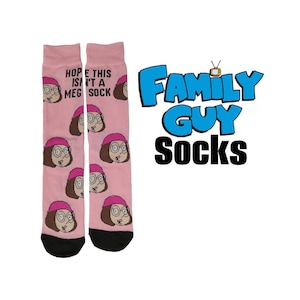 May include: Pink socks featuring the character Meg from Family Guy, with the phrase "HOPE THIS ISN'T A MEG SOCK" printed on one sock. The Family Guy logo is in blue, with the word "SOCKS" in black.