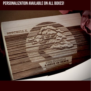 May include: A wooden box with a laser-engraved design of a bonsai tree. The text "Find Yourself A Piece of Peace" is engraved below the tree. The box is personalized with the name "Mitchell E."