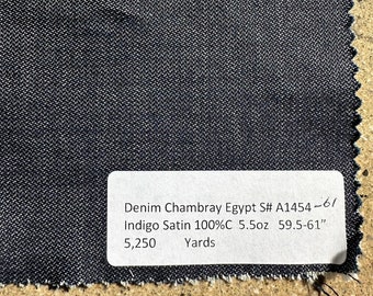 May include: A dark blue denim chambray fabric swatch with a white label that reads "Denim Chambray Egypt S# A1454-61 Indigo Satin 100%C 5.5oz 59.5-61" 5,250 Yards".