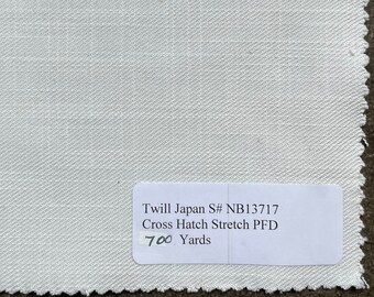 May include: White fabric swatch with a label that reads "Twill Japan S# NB13717 Cross Hatch Stretch PFD 700 Yards".