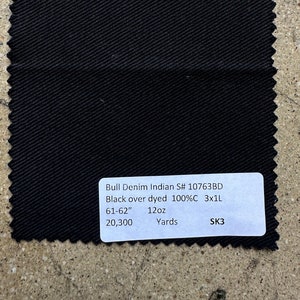 May include: Black denim fabric swatch with the text "Bull Denim Indian S# 10763BD Black over dyed 100%C 3x1L 61-62" 12oz Yards SK3 20,300"