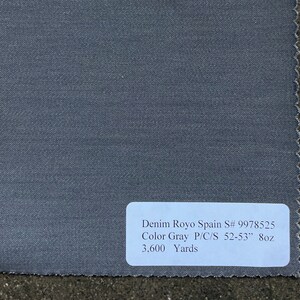 May include: A sample of gray denim fabric with the text "Denim Royo Spain S# 9978525 Color Gray P/C/S 52-53" 8oz 3,600 Yards".