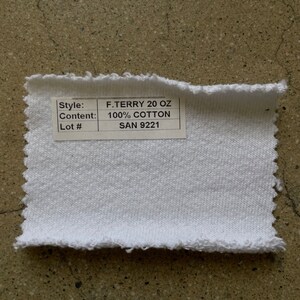 May include: White fabric swatch with a label that reads "Style: F.TERRY 20 OZ, Content: 100% COTTON, Lot#: SAN 9221".