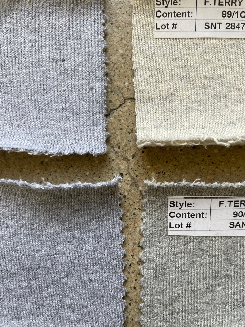 May include: Four fabric swatches with different colors and textures. The swatches are labeled with style, content, and lot numbers. The top left swatch is a light gray, the top right swatch is a light beige, the bottom left swatch is a medium gray, and the bottom right swatch is a dark gray.