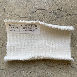 May include: A white cotton fabric swatch with a label that reads "Style: F. TERRY 25 OZ, Content: 100% COTTON, Lot #: SAN 103011".