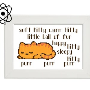 May include: A white framed cross-stitch design featuring a cartoon orange cat sleeping with the text "soft Kitty warm Kitty little ball of fur happy Kitty sleepy Kitty purr purr purr"