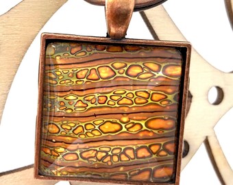 Oranjegele en zwarte vierkante cabachonhanger of sleutelhanger