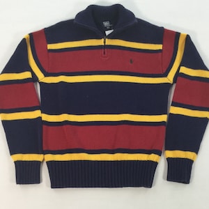 May include: A blue, red, and yellow striped sweater with a quarter zip closure and a small polo player logo on the chest.