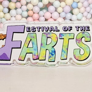 May include: A purple dragon with a white background and the text "Festival of the Arts" in colorful tie-dye lettering.