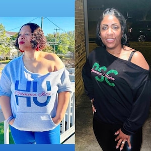 May include: Two women wearing off-the-shoulder sweatshirts with Greek letters and glitter. The woman on the left is wearing a gray sweatshirt with "HU Gamma Iota" in blue and pink letters. The woman on the right is wearing a black sweatshirt with "DSC Gamma Alpha" in green and pink letters.