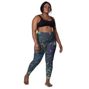May include: Black and blue high-waisted leggings with a colorful abstract print. The leggings are made of a stretchy, comfortable fabric and have a high waistband for a flattering fit.