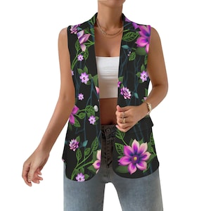 May include: A sleeveless black vest with a floral print featuring pink and purple flowers on a dark green leafy background. The vest has a collar and a button closure.
