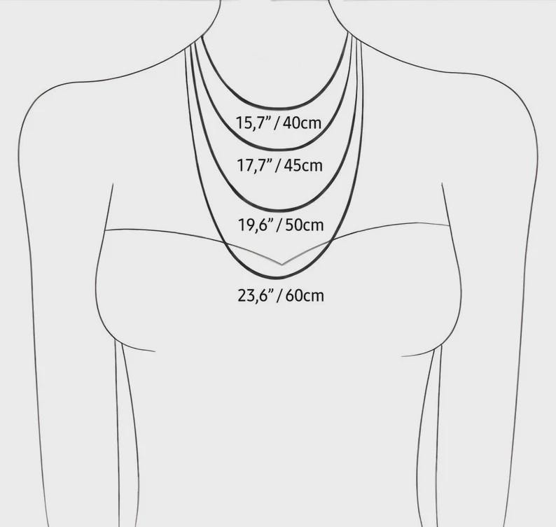 May include: A diagram showing the lengths of four necklaces. The necklaces are displayed at 15.7 inches/40cm, 17.7 inches/45cm, 19.6 inches/50cm, and 23.6 inches/60cm. The image is of a person from the neck down, wearing the necklaces.