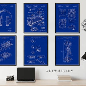 May include: Six framed blue and white patent prints displayed on a wall, featuring technical diagrams of various electronic devices including headphones, a disk drive, and mechanical components, with a digital download shield icon in the corner.